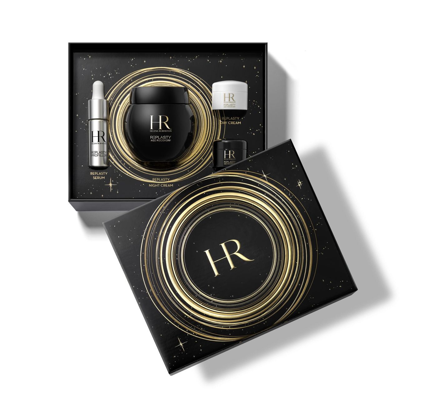 Couvercle de coffret cadeau noir avec le logo "HR" dore au centre, entoure de spirales lumineuses et de motifs etoiles, sur fond blanc reflechissant.